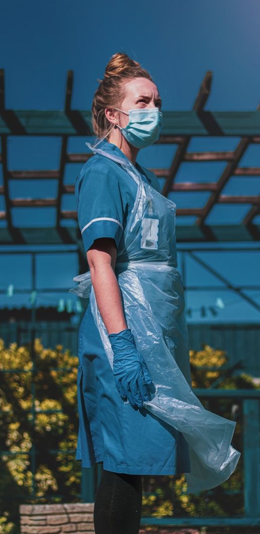 woman in blue and white polo shirt standing on yellow flower field during daytime