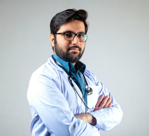 man in white dress shirt wearing black framed eyeglasses